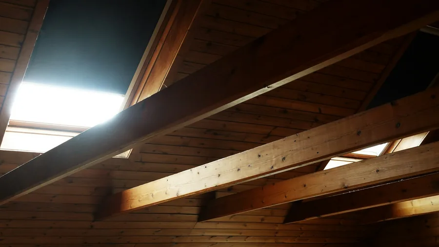 Open wall framing showing empty stud cavities before insulation